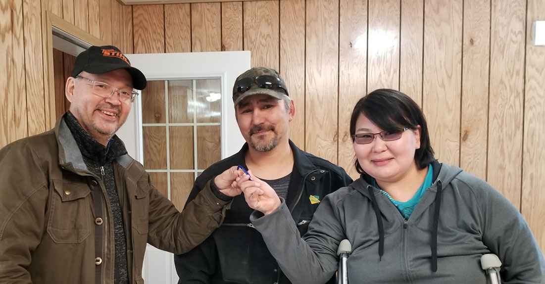 Young couple given the keys to their home.
